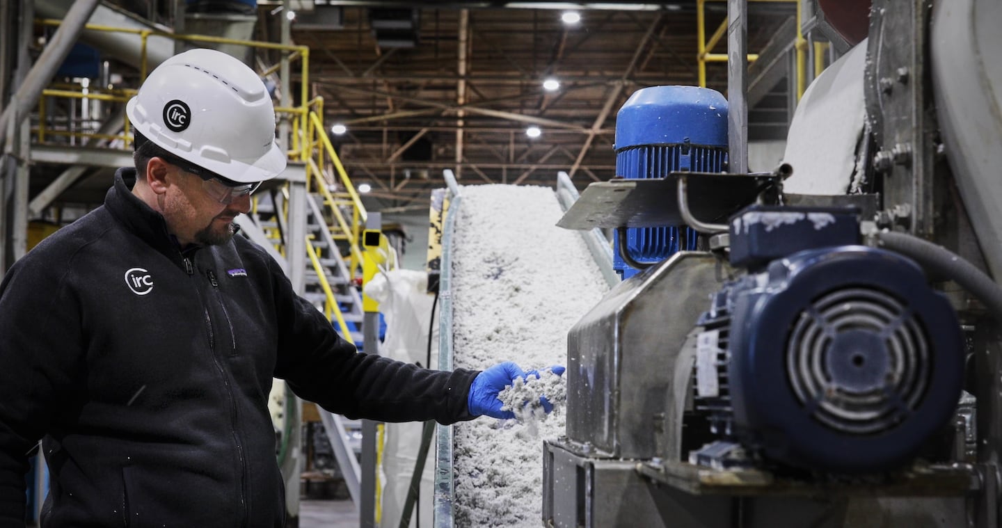 Worker in textile recycling factory.